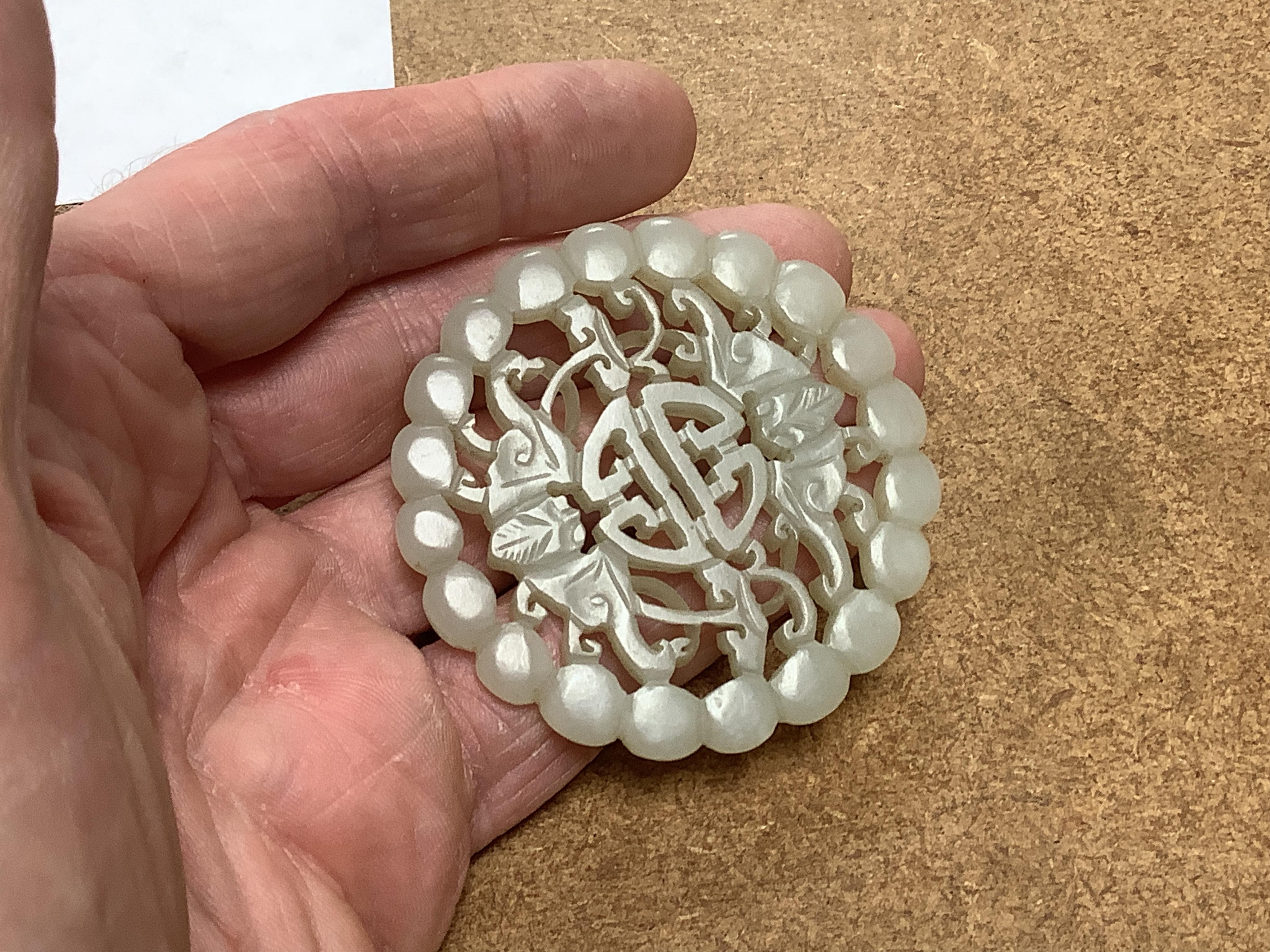 Two Chinese celadon jade circular plaques, 19th century, 5.5cm diameter